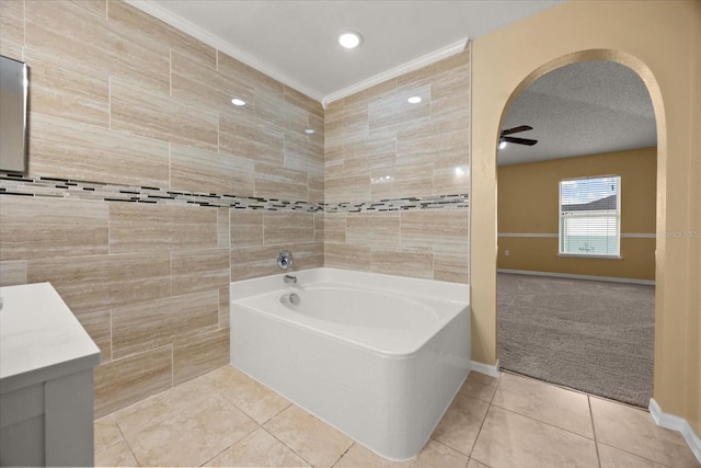 2725 White Magnolia Loop, Clermont, FL 34711 - bathroom featuring tile patterned flooring, a garden tub, a ceiling fan, vanity, and tile walls