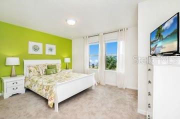 1512 Mumbai Way, Kissimmee, FL 34747 - bedroom featuring light carpet and baseboards
