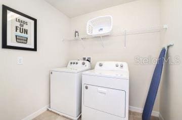1512 Mumbai Way, Kissimmee, FL 34747 - laundry room featuring washing machine and dryer and baseboards