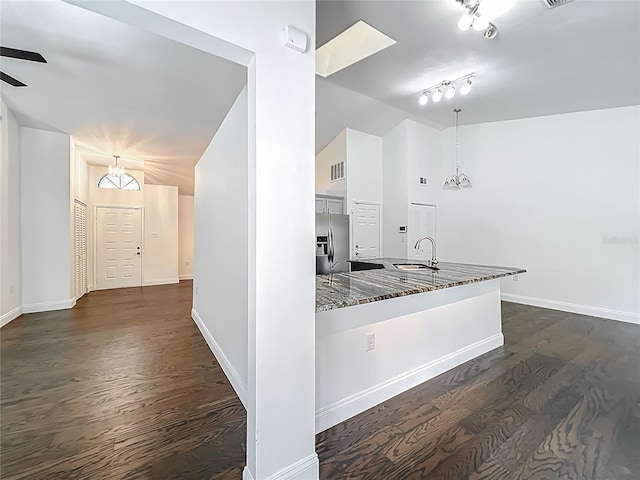 4274 Meeting Pl, Sanford, FL 32773 - kitchen featuring vaulted ceiling, stainless steel fridge, dark stone countertops, dark wood-style floors, and a ceiling fan