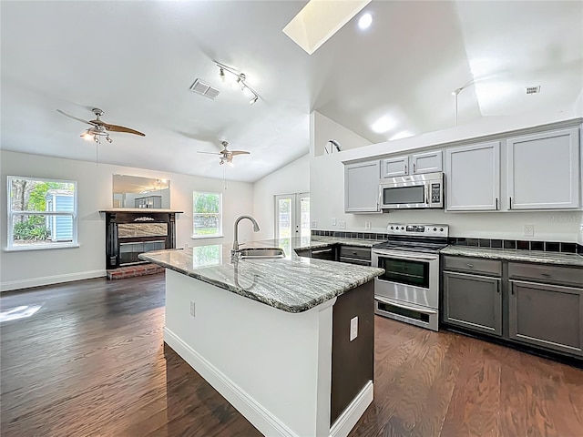 4274 Meeting Pl, Sanford, FL 32773 - kitchen with appliances with stainless steel finishes, gray cabinetry, dark wood-style flooring, and lofted ceiling