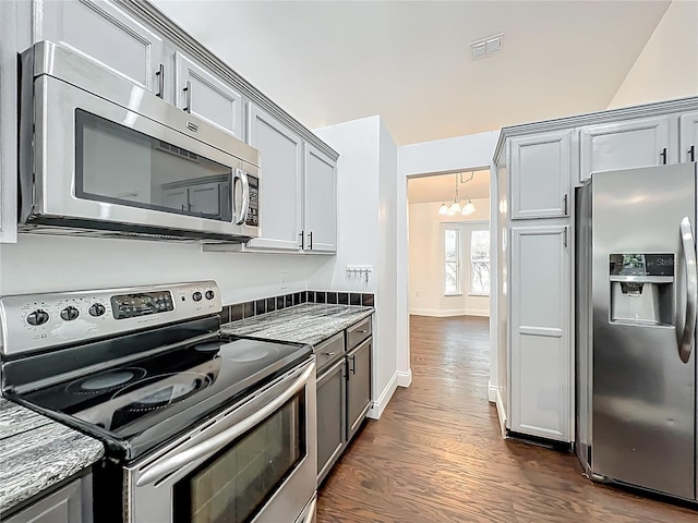 4274 Meeting Pl, Sanford, FL 32773 - kitchen featuring stainless steel appliances, a chandelier, dark wood-type flooring, gray cabinets, and dark stone counters