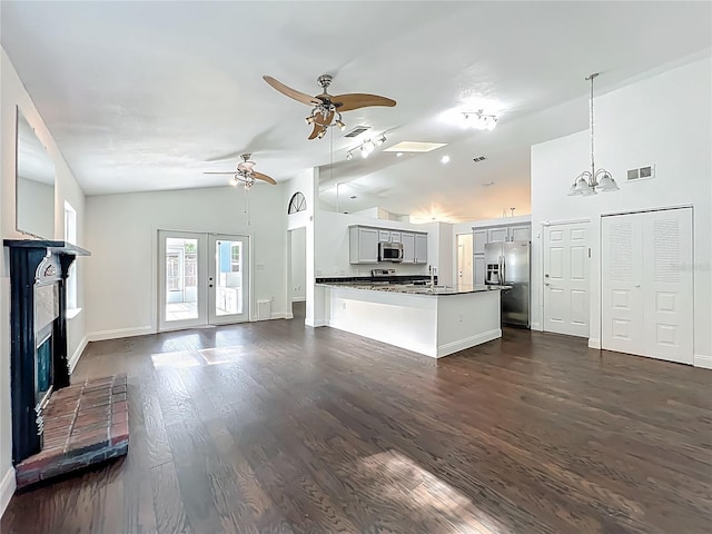 4274 Meeting Pl, Sanford, FL 32773 - unfurnished living room featuring ceiling fan, dark wood-type flooring, a brick fireplace, a chandelier, and high vaulted ceiling