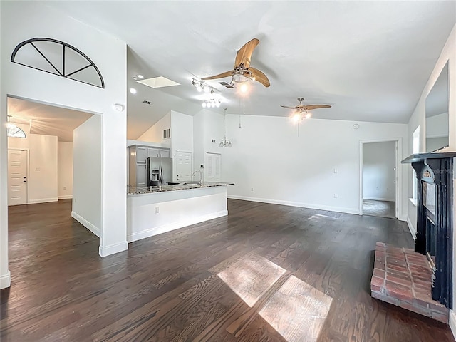4274 Meeting Pl, Sanford, FL 32773 - unfurnished living room with ceiling fan, a brick fireplace, dark wood-type flooring, and high vaulted ceiling