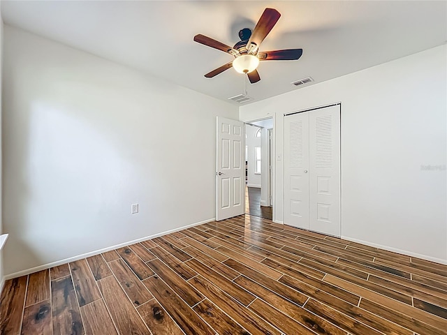 4274 Meeting Pl, Sanford, FL 32773 - unfurnished bedroom with dark wood-style flooring, a closet, and a ceiling fan