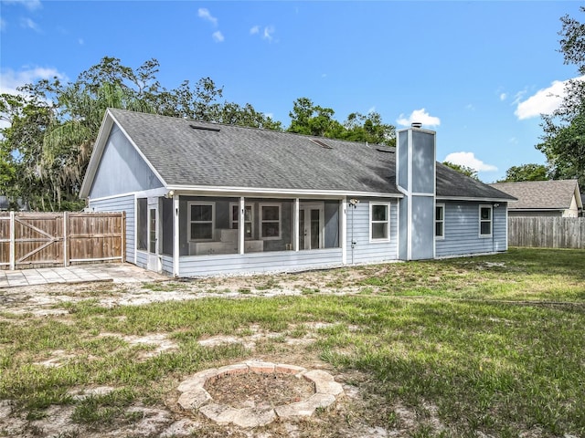4274 Meeting Pl, Sanford, FL 32773 - back of house featuring a sunroom, a fenced backyard, a shingled roof, and a chimney