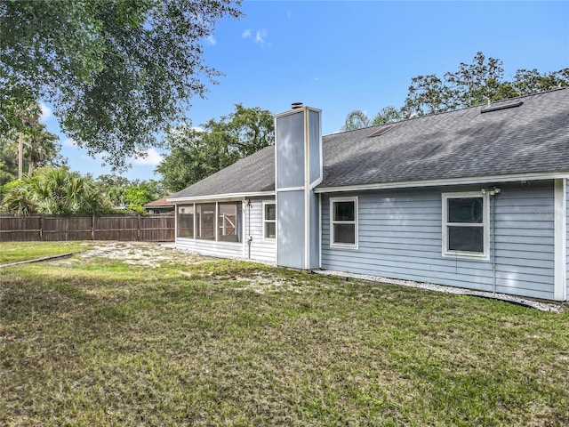 4274 Meeting Pl, Sanford, FL 32773 - back of property featuring a sunroom, a chimney, and a shingled roof