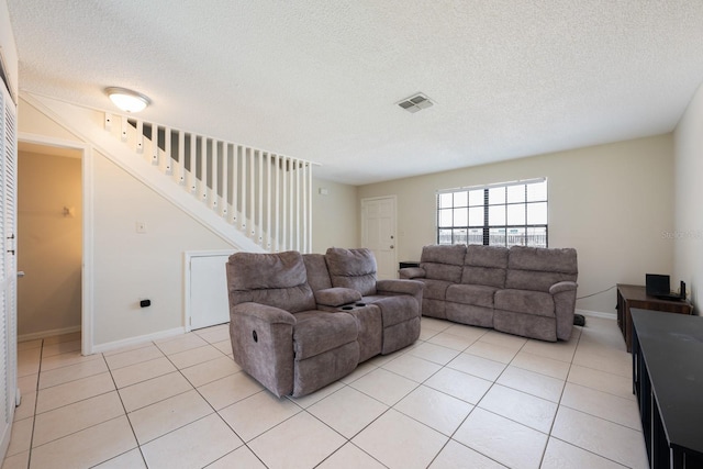 1300 Arlington Ln NE Unit 111, Palm Bay, FL 32905 - living area with stairway, a textured ceiling, and light tile patterned flooring
