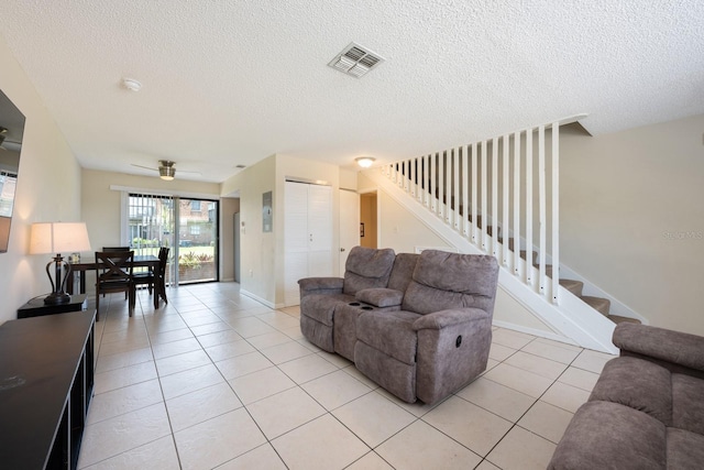 1300 Arlington Ln NE Unit 111, Palm Bay, FL 32905 - living area featuring stairs, light tile patterned floors, and a textured ceiling