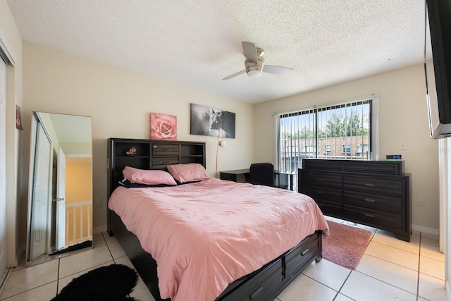 1300 Arlington Ln NE Unit 111, Palm Bay, FL 32905 - bedroom with light tile patterned floors, ceiling fan, and a textured ceiling