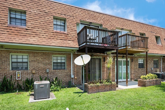 1300 Arlington Ln NE Unit 111, Palm Bay, FL 32905 - back of property with brick siding, a lawn, and mansard roof