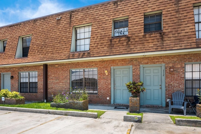 1300 Arlington Ln NE Unit 111, Palm Bay, FL 32905 - view of front of home featuring brick siding and mansard roof