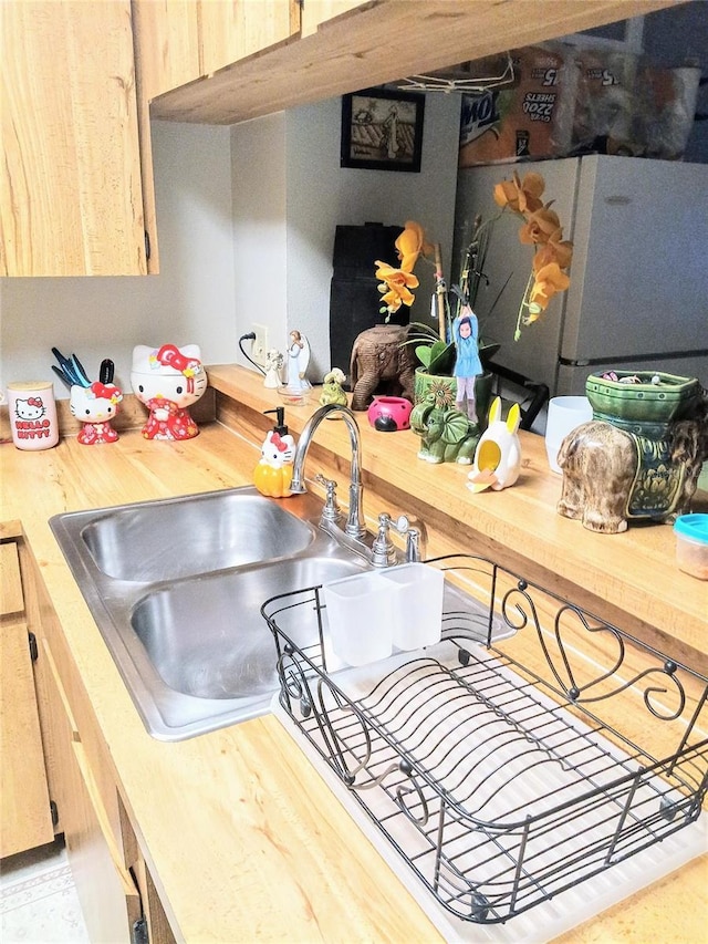 6640 121st Ave Unit 1, Largo, FL 33773 - kitchen with freestanding refrigerator and light brown cabinets