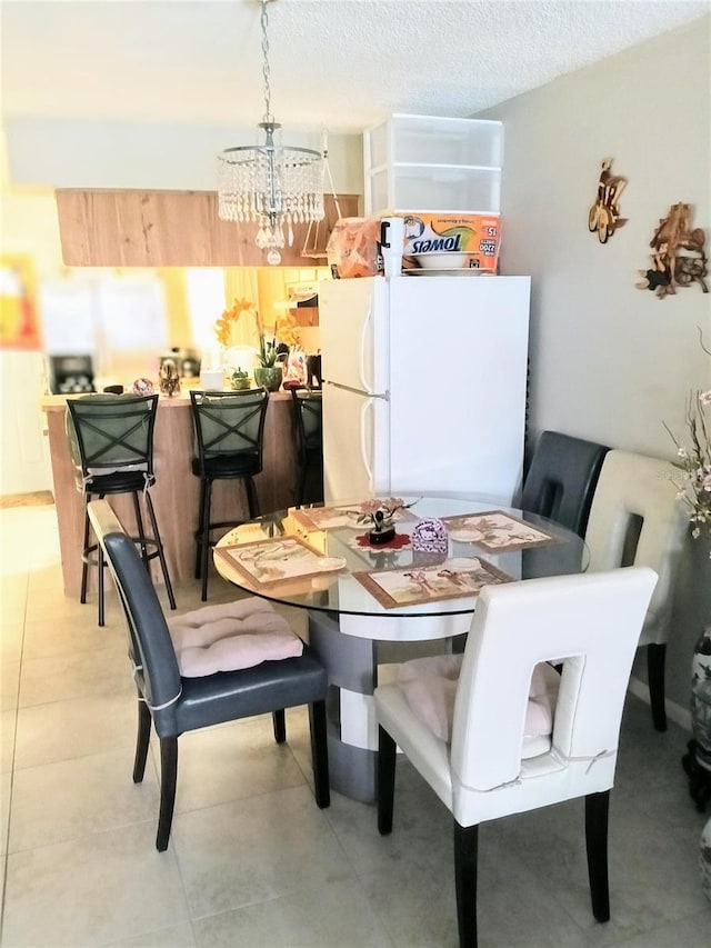 6640 121st Ave Unit 1, Largo, FL 33773 - dining area featuring a chandelier and a textured ceiling