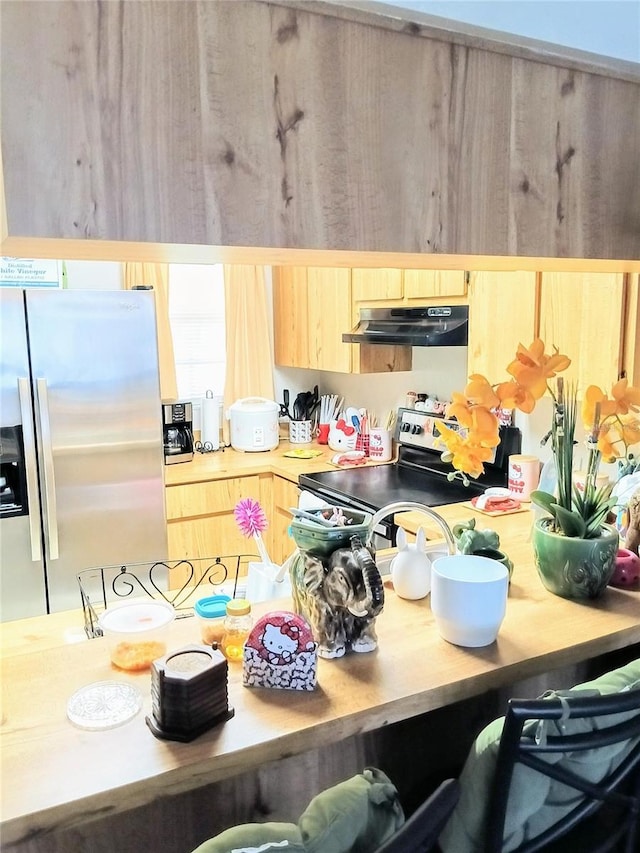 6640 121st Ave Unit 1, Largo, FL 33773 - kitchen with appliances with stainless steel finishes, under cabinet range hood, light brown cabinetry, and light countertops