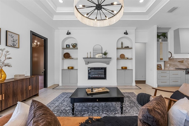 2873 Bellwind Cir, Rockledge, FL 32955 - living area featuring a tray ceiling, built in features, light tile patterned flooring, a chandelier, and ornamental molding
