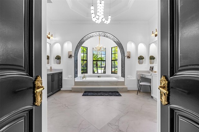 2873 Bellwind Cir, Rockledge, FL 32955 - full bathroom featuring a chandelier, a garden tub, marble tiled floors, vanity, and ornamental molding