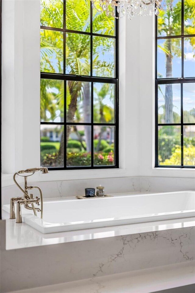 2873 Bellwind Cir, Rockledge, FL 32955 - bathroom with a bath and a chandelier