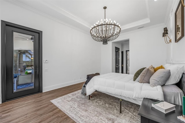 2873 Bellwind Cir, Rockledge, FL 32955 - bedroom with wood finished floors, a chandelier, crown molding, and a raised ceiling