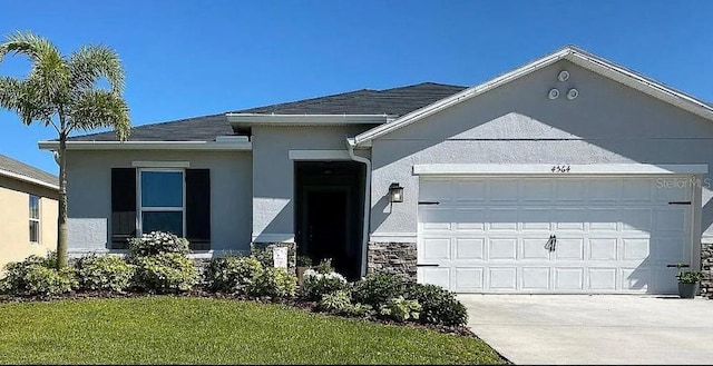 4564 Orchard Grove Rd, Saint Cloud, FL 34772 - ranch-style home featuring a garage, stucco siding, driveway, and a front lawn