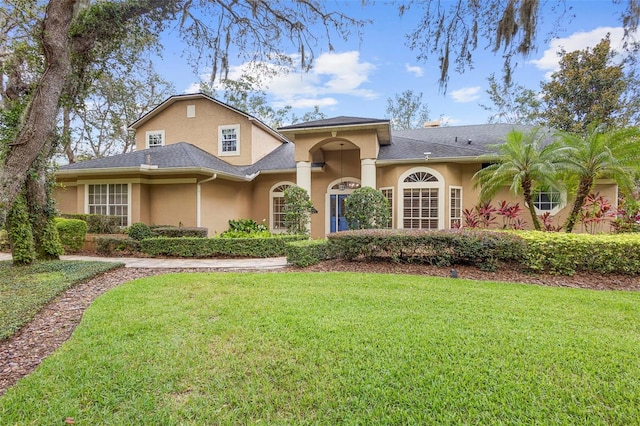 1689 Wingspan Way, Winter Springs, FL 32708 - view of front of house with stucco siding and a front lawn