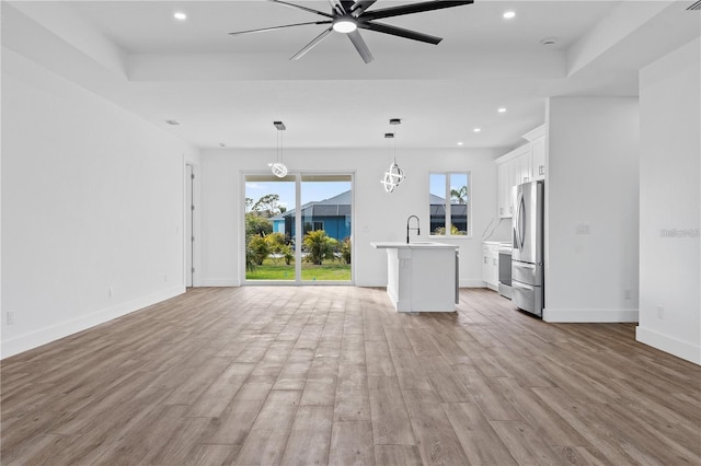 10071 Kingsville Dr, Port Charlotte, FL 33981 - unfurnished living room featuring light wood-style flooring, ceiling fan, and recessed lighting