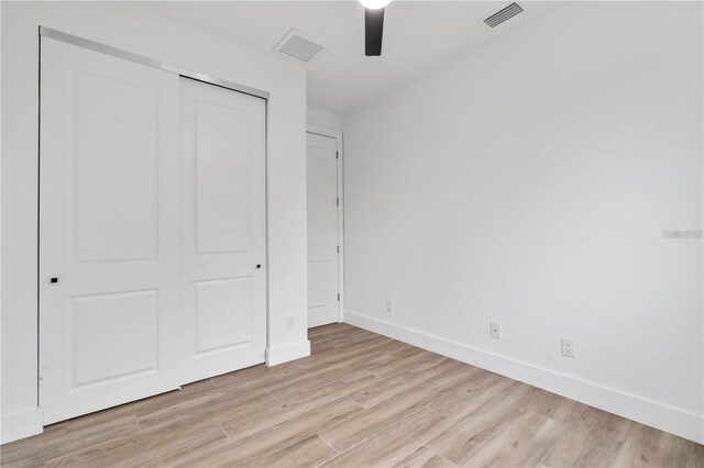 10071 Kingsville Dr, Port Charlotte, FL 33981 - unfurnished bedroom with light wood finished floors, a closet, and ceiling fan