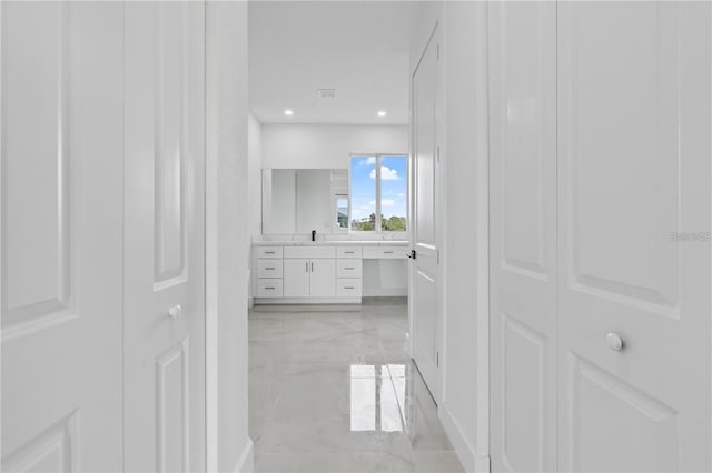 10071 Kingsville Dr, Port Charlotte, FL 33981 - corridor featuring light marble finish floors and recessed lighting