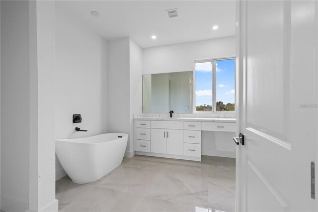 10071 Kingsville Dr, Port Charlotte, FL 33981 - full bath featuring vanity, a soaking tub, marble tiled flooring, and recessed lighting