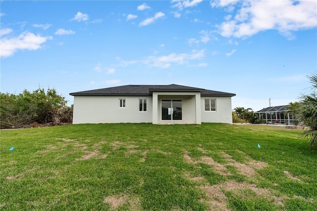 10071 Kingsville Dr, Port Charlotte, FL 33981 - back of property with stucco siding and a yard