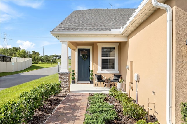 3279 Canna Lily Pl, Clermont, FL 34711 - doorway to property with covered porch, stucco siding, and a shingled roof
