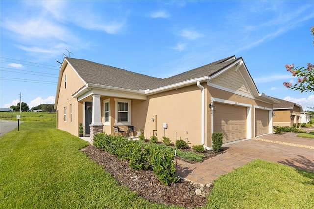 3279 Canna Lily Pl, Clermont, FL 34711 - view of property exterior with an attached garage, stucco siding, a lawn, and driveway