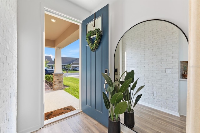 3279 Canna Lily Pl, Clermont, FL 34711 - entrance foyer featuring brick wall, wood finished floors, and ornate columns