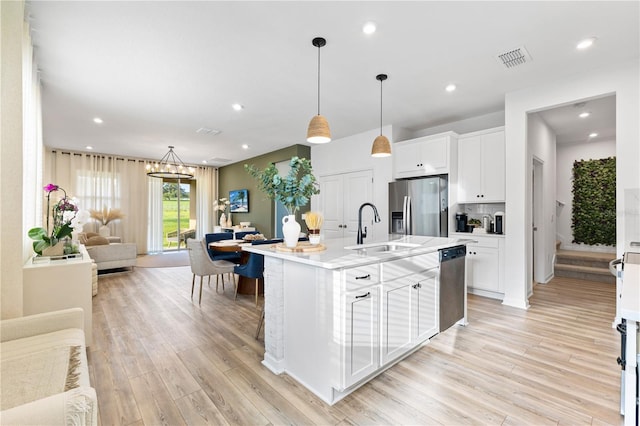 3279 Canna Lily Pl, Clermont, FL 34711 - kitchen featuring stainless steel appliances, open floor plan, light wood-style flooring, light countertops, and recessed lighting