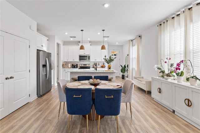 3279 Canna Lily Pl, Clermont, FL 34711 - dining space featuring light wood finished floors and recessed lighting