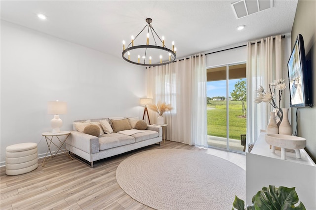 3279 Canna Lily Pl, Clermont, FL 34711 - living room with light wood-type flooring, a chandelier, and recessed lighting