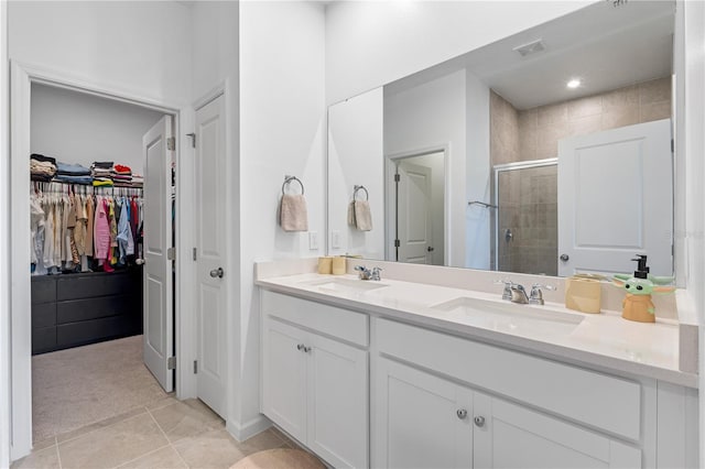 3279 Canna Lily Pl, Clermont, FL 34711 - full bathroom with a stall shower, double vanity, a walk in closet, and tile patterned flooring