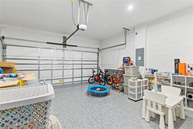 3279 Canna Lily Pl, Clermont, FL 34711 - garage with electric panel, concrete block wall, and a garage door opener