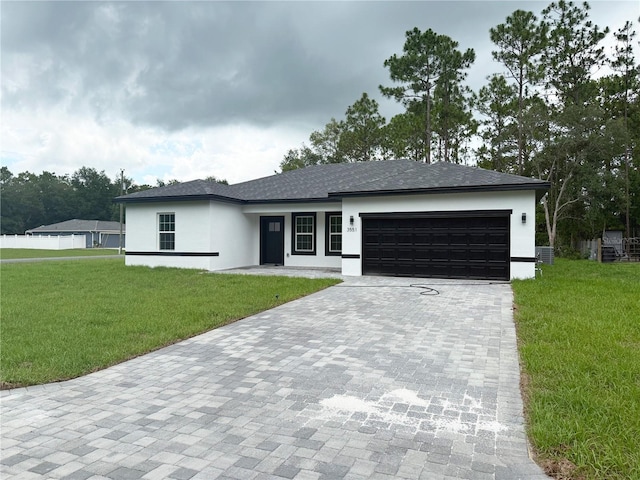 3551 W Fleece Dr, Dunnellon, FL 34433 - view of front of house with decorative driveway, a garage, stucco siding, and a front lawn