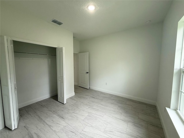 3551 W Fleece Dr, Dunnellon, FL 34433 - unfurnished bedroom featuring light marble finish flooring and a closet