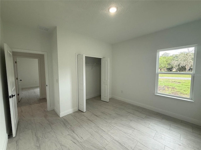 3551 W Fleece Dr, Dunnellon, FL 34433 - unfurnished bedroom featuring light marble finish flooring and a closet