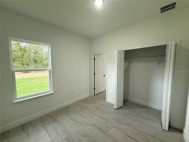 3551 W Fleece Dr, Dunnellon, FL 34433 - unfurnished bedroom with a closet and light marble finish flooring