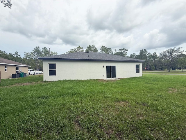 3551 W Fleece Dr, Dunnellon, FL 34433 - back of house featuring a yard and stucco siding