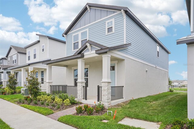16526 Silver Brook Way, Winter Garden, FL 34787 - view of front facade with a porch, a front lawn, board and batten siding, stucco siding, and a residential view