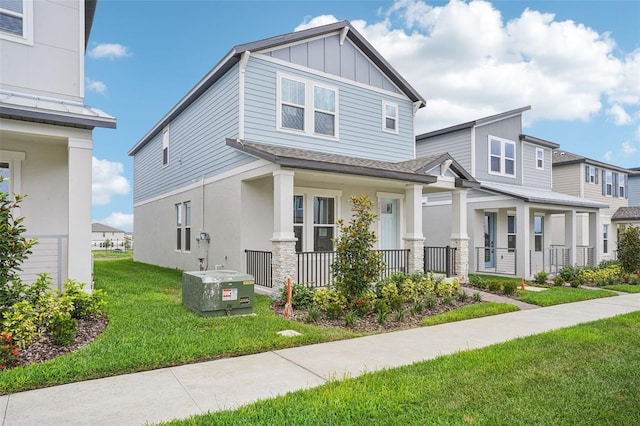 16526 Silver Brook Way, Winter Garden, FL 34787 - view of front facade with a porch, board and batten siding, a front yard, roof with shingles, and stone siding