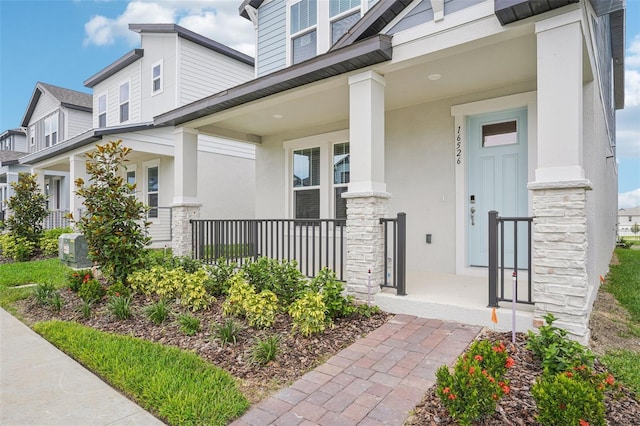 16526 Silver Brook Way, Winter Garden, FL 34787 - property entrance featuring stone siding, covered porch, and stucco siding