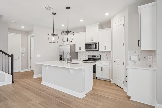 16526 Silver Brook Way, Winter Garden, FL 34787 - kitchen with stainless steel appliances, light wood-style flooring, light countertops, backsplash, and white cabinetry