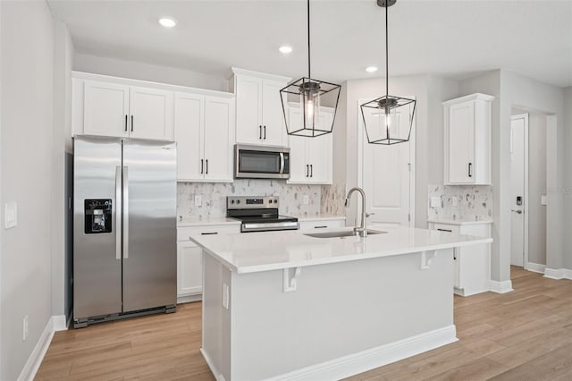 16526 Silver Brook Way, Winter Garden, FL 34787 - kitchen with appliances with stainless steel finishes, decorative backsplash, light wood-style flooring, white cabinets, and recessed lighting