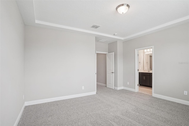 16526 Silver Brook Way, Winter Garden, FL 34787 - unfurnished bedroom featuring light carpet, a raised ceiling, and ensuite bathroom