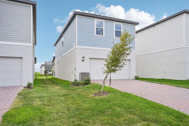 16526 Silver Brook Way, Winter Garden, FL 34787 - view of side of home featuring stucco siding, an attached garage, a lawn, and decorative driveway